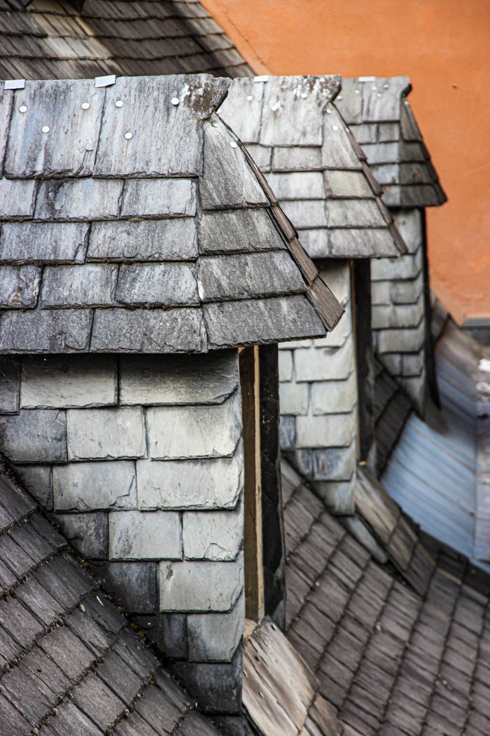 Close-up of traditional slate rooftops in Lourdes, Occitania, showcasing classic French architecture.